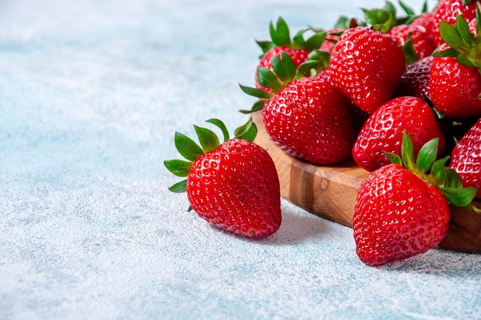 Fresh strawberries on wooden board