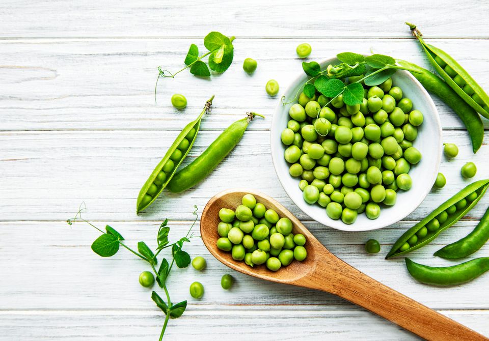 Green peas with pea leaves and pods