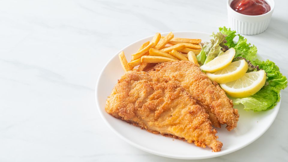 Homemade Heavenly chicken with french fries, lemons, lettuce, and dip
