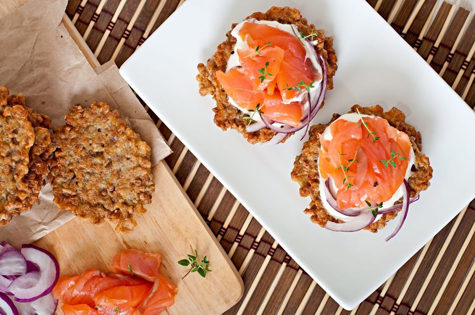 Salmon-topped patties with sour cream and red onion