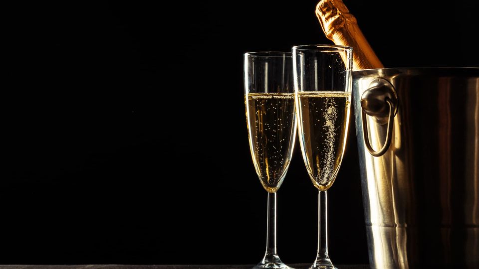 Champagne flutes with a bottle in an ice bucket