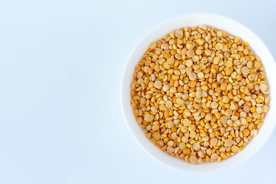Yellow split peas in a white bowl