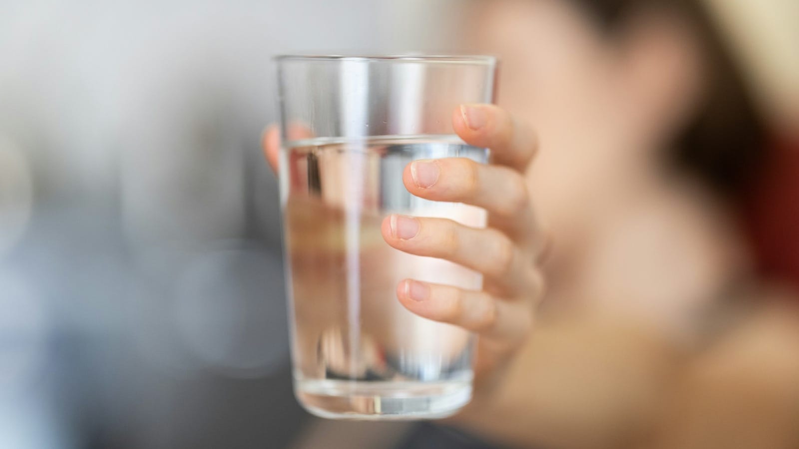 person holding clear drinking glass