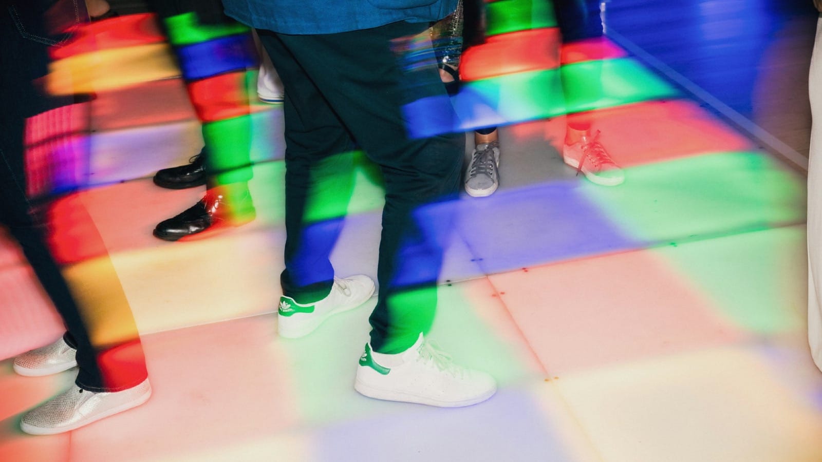 a group of people wearing colorful shoes