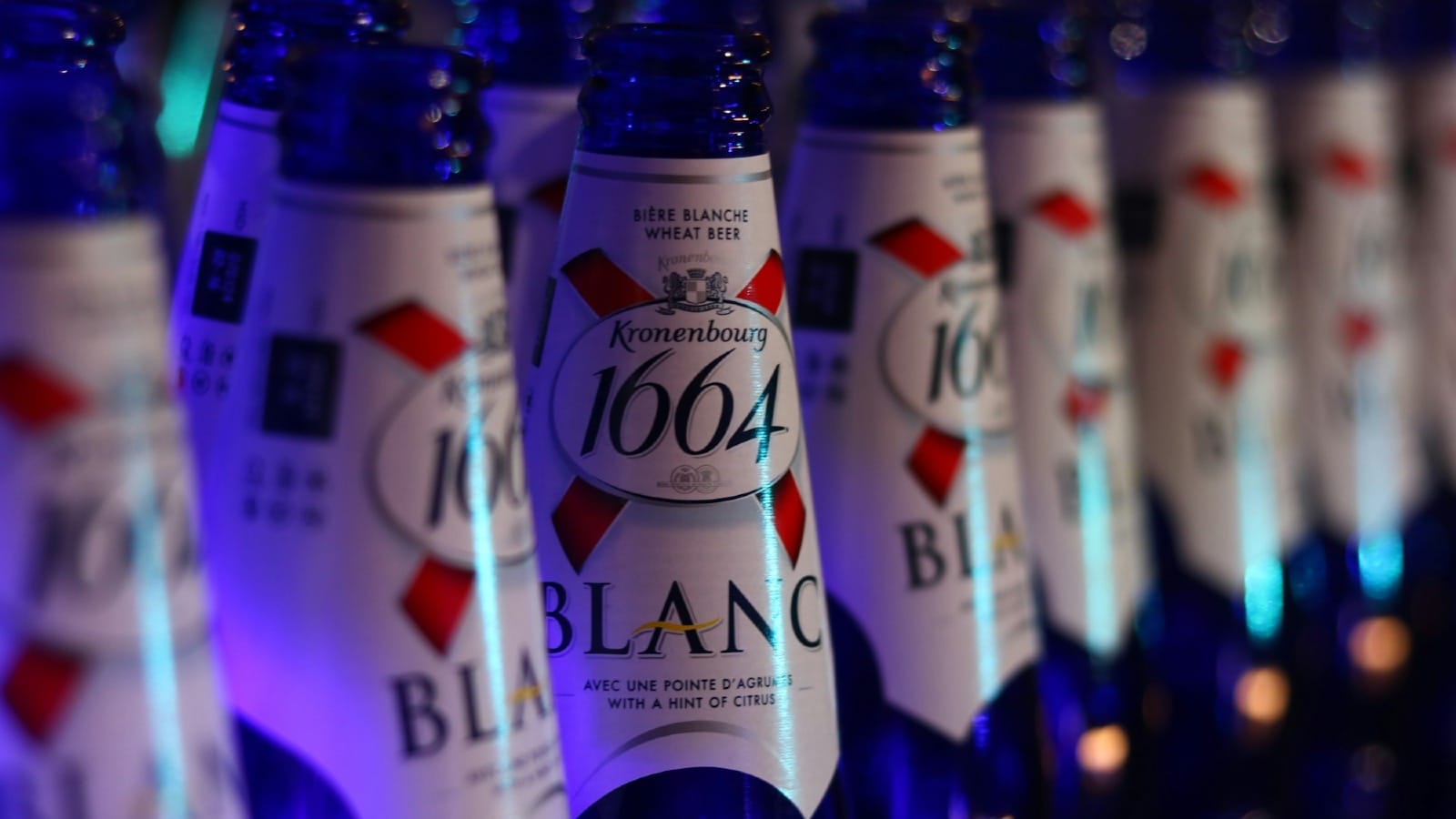 a row of bottles of alcohol sitting on a shelf