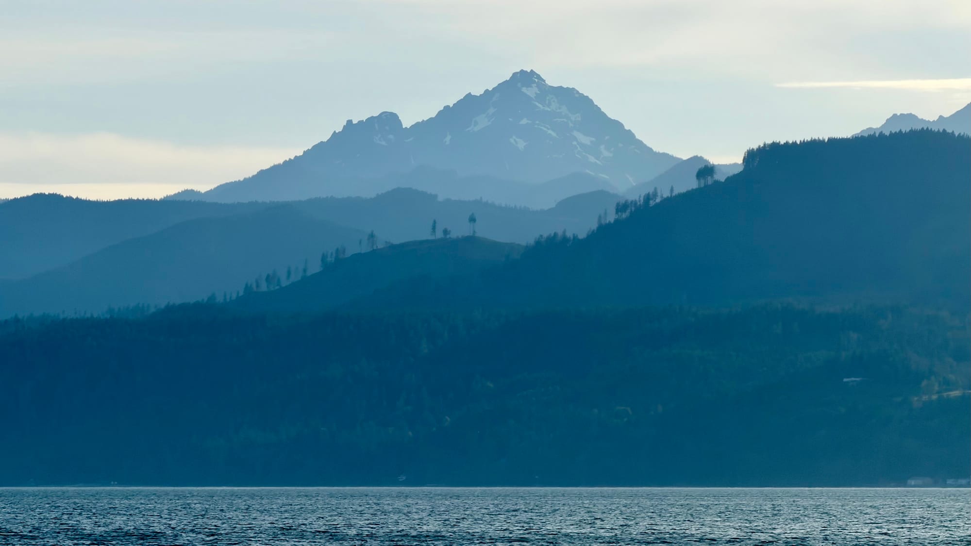 A mountain as seen in the distance, across a body of water.