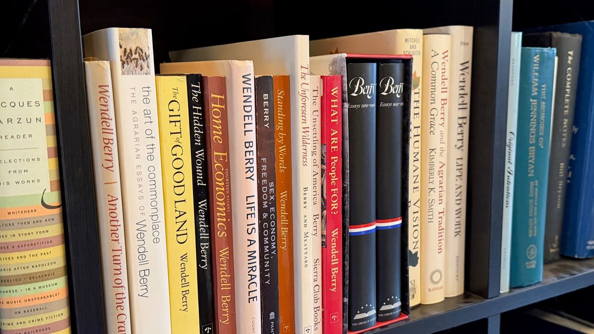 Volumes of Wendell Berry’s essays sit on a black bookshelf. (Photo by Scott P. Richert)