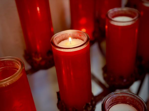 A devotional candle in a red glass holder at SS. Peter and Paul Catholic Church in Huntington, Indiana.