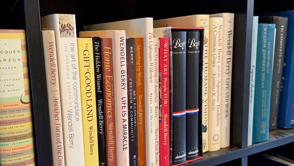 Volumes of Wendell Berry’s essays sit on a black bookshelf. (Photo by Scott P. Richert)