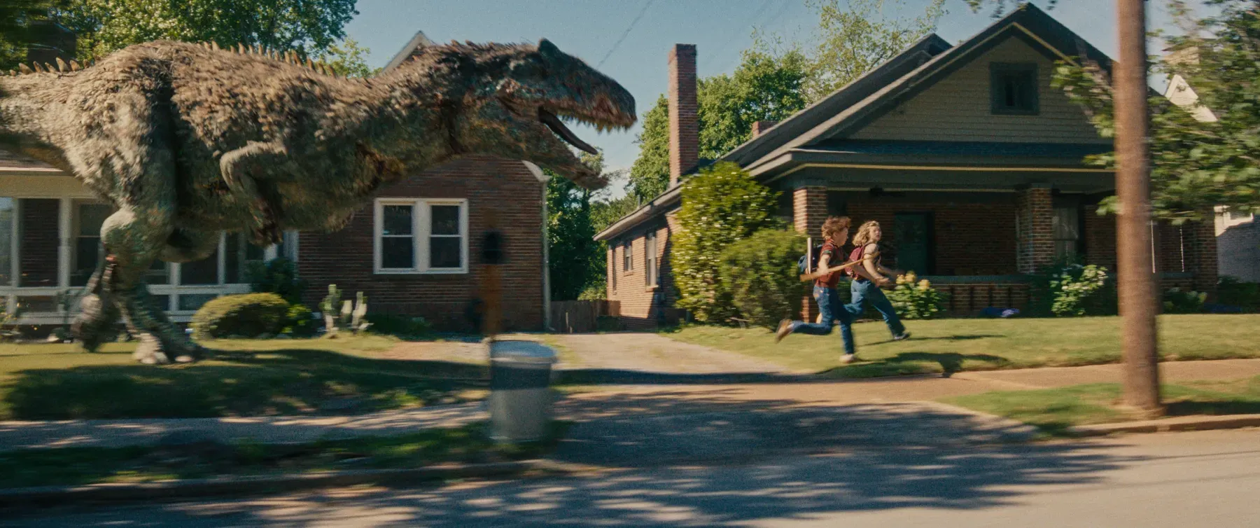 Our heroes run away from an angry dinosaur in The End of Oak Street