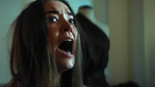A woman screaming at something off camera in the film 1BR