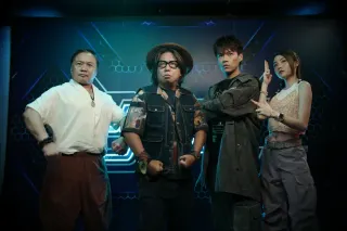 The cast of Good Game posing in front of a gaming themed wall. 