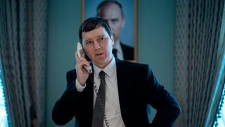 Paul Dano on the phone in a nondescript office in the film The Wizard of the Kremlin