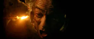 Jonathan Lambert as Luc in the film Flush, here with his head stuck in a squat toilet, screaming into the darkness. 