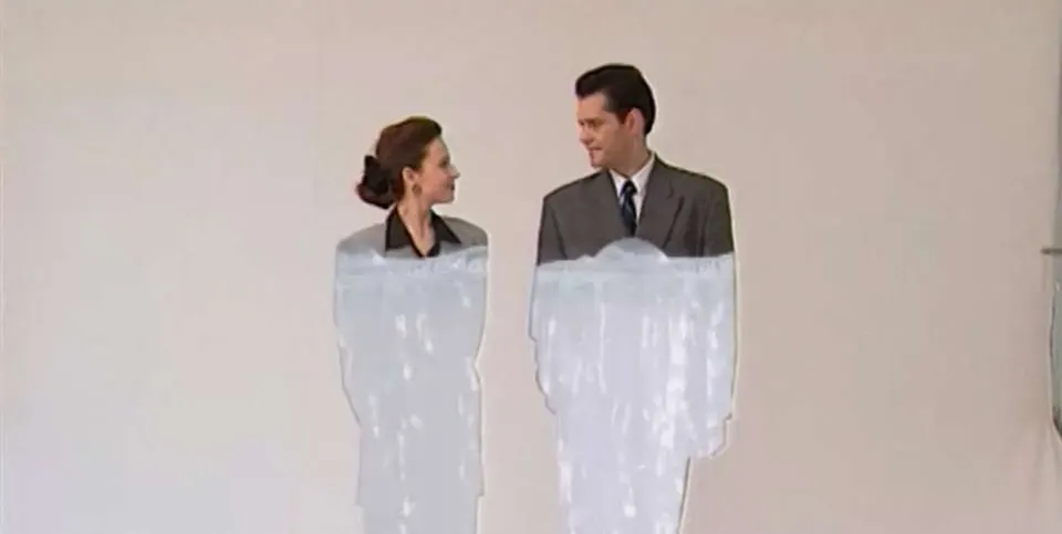 A man and a woman stare at each other as their clothes are colored in from top to bottom in the film Eight Postcards from Utopia