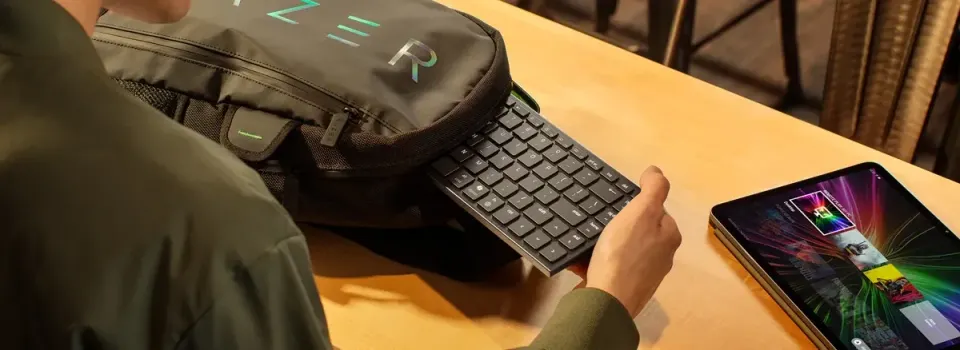 Product image for the Razer Joro with a person taking the thin laptop out of a backpack.