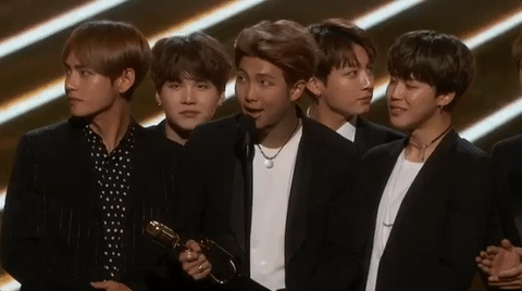 Animated gif of BTS accepting an award onstage