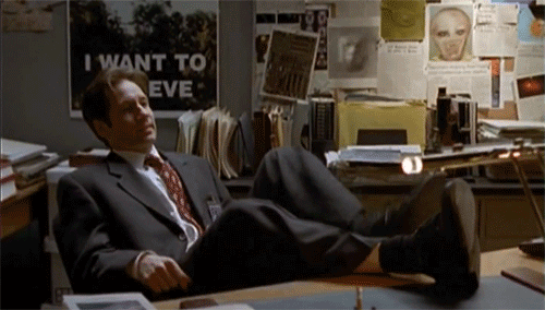  Fox Mulder leaning back in his chair, overbalancing, and falling down. 