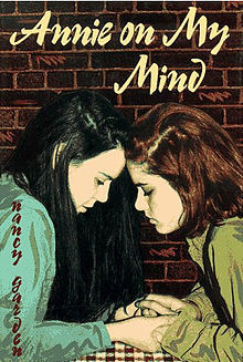  The cover of  Annie On My Mind , by Nancy Garden: two teen girls clasp hands and press their foreheads together. 