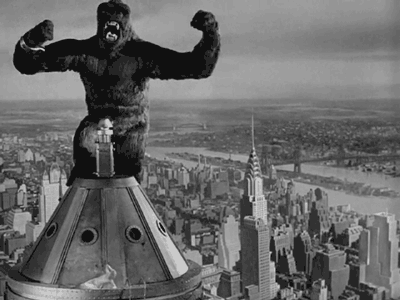  An animated gif of King Kong, from the early animated film, beating his chest atop the Empire State Building. 