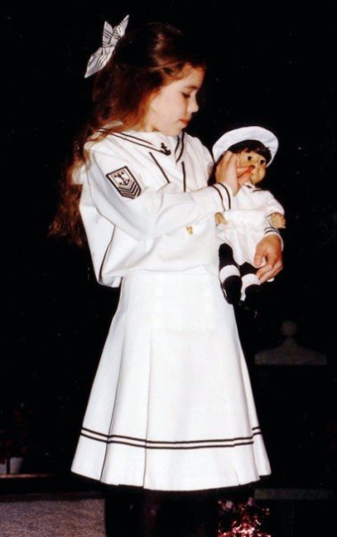  Elizabeth as a child, carrying her Samantha doll. Both are dressed in matching sailor dresses. 
