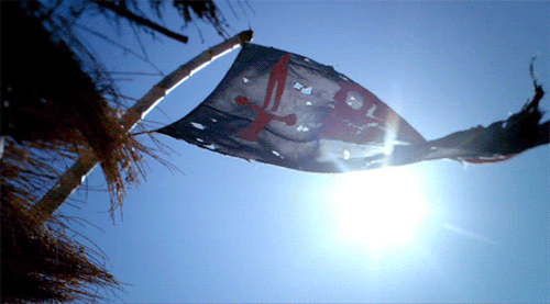  An animated gif of a tattered pirate flag flying in the sun. 