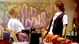  An animated gif of Bill and Ted from  Bill and Ted’s Excellent Adventure  shouting “Excellent!” and playing air guitar. 