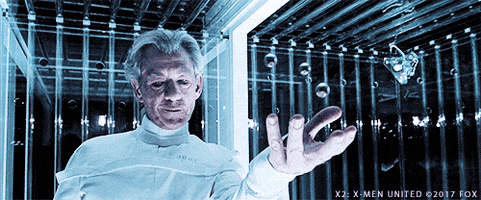 Animated gif of Magneto (aka Best Erik) rotating metal balls in the air and winking