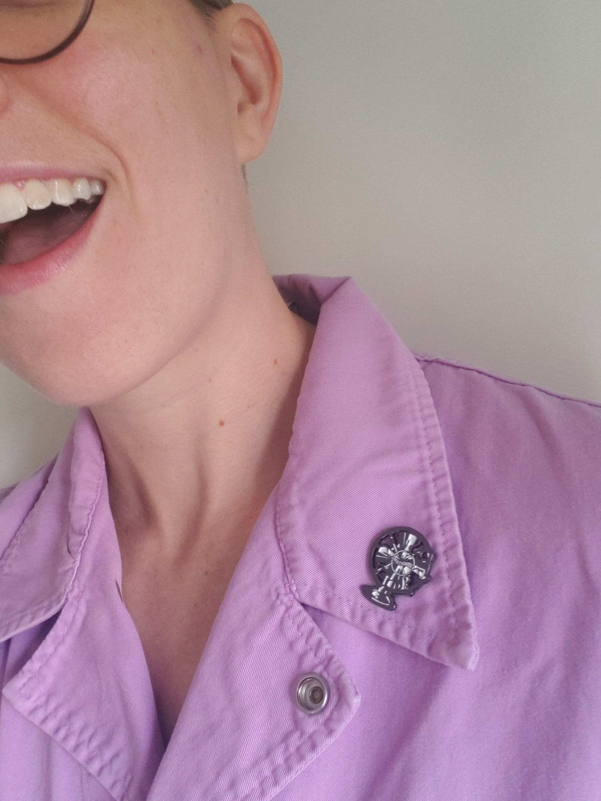  Flourish models a Fansplaining pin on their lapel. 