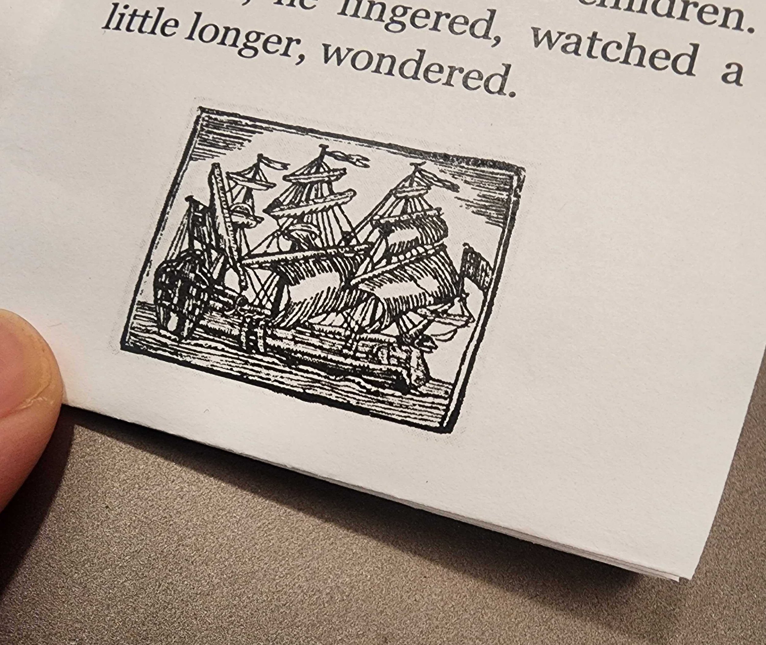 Photo of a page of the Tiny Zine. The words "lingered, watched a little longer, and wondered" followed by a line drawing of a sailing ship.
