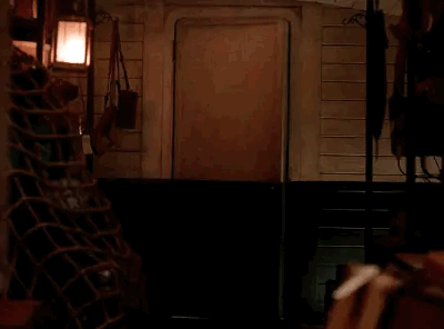 Animated gif of Lestat hopping through a swinging train car door holding a severed head.
