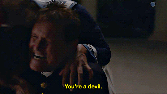 Animated gif of Claudia jumping on a police officer who says, "You're a devil."
