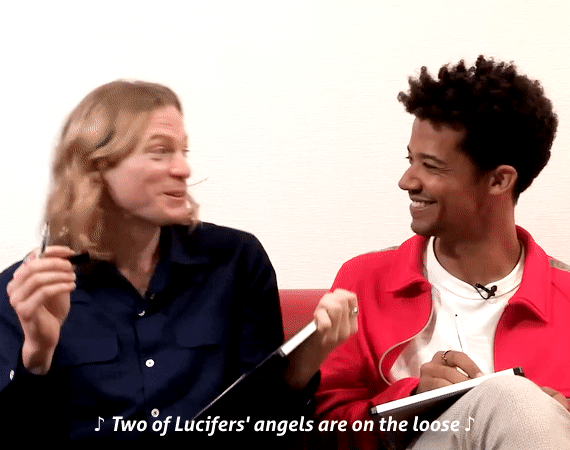 Animated gif of Sam Reid and Jacob Anderson, with Sam shimmying and singing "Two of Lucifers' angels are on the loose"