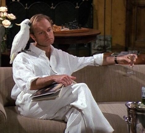  Niles looks nonplussed (in all white, with a glass of white wine and a bird) 