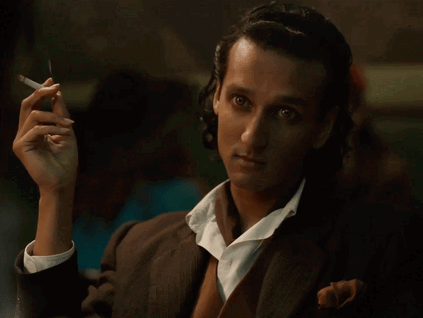 Animated gif of Armand from the IWTV s2 trailer, dressed in a 1940s suit and smoking a cigarette.