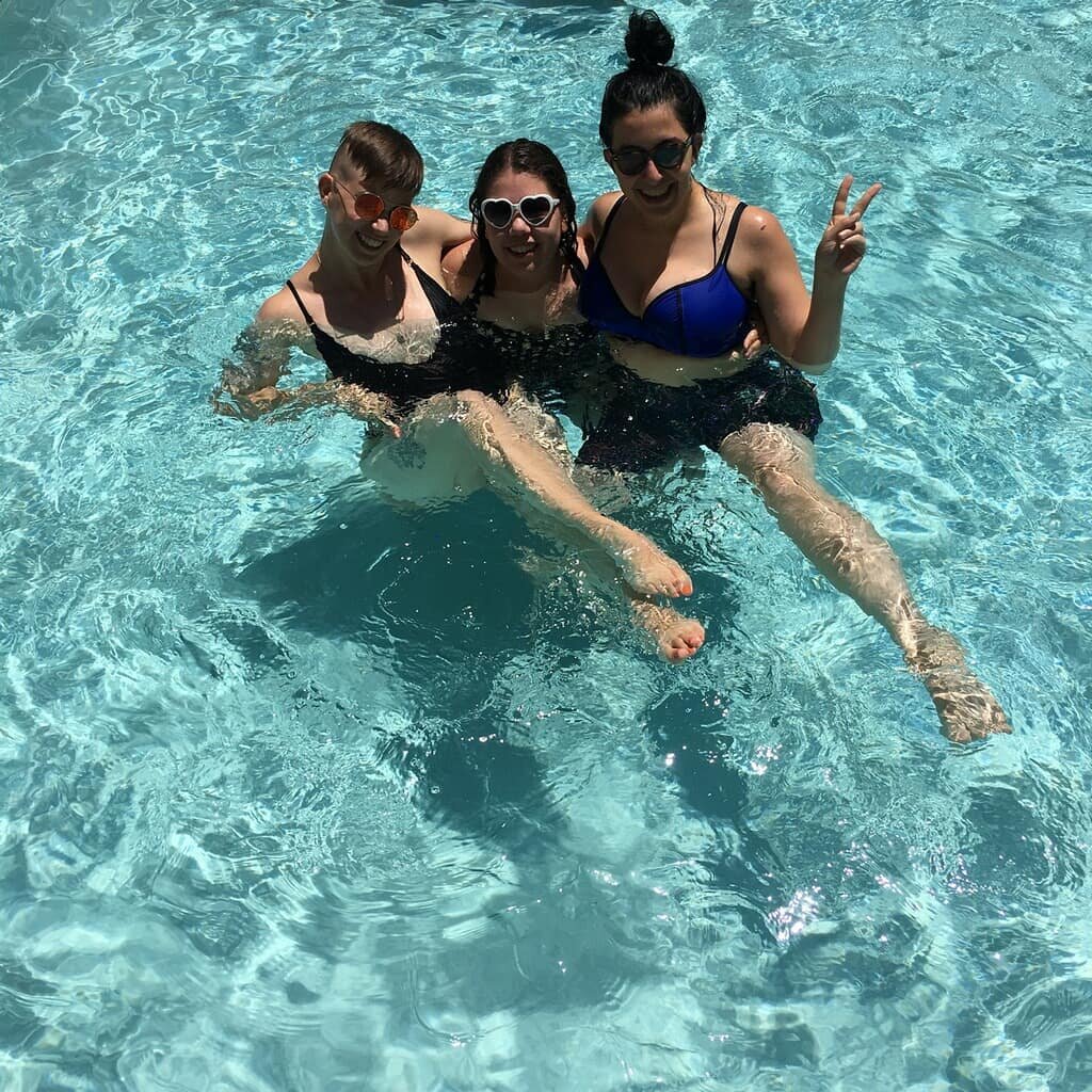  Flourish, Nozlee, and Elizabeth relax in a pool. 