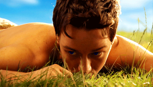Animated gif from the Children of Dune miniseries featuring a very young James McAvoy, lying shirtless face-down in the grass