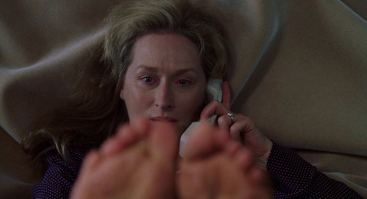 Photo of Meryl Streep in Adaptation staring at her feet while talking on the phone