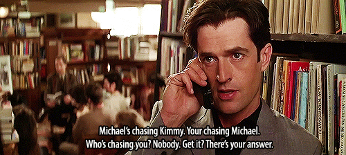 Animated gif of Rupert Everett in My Best Friend's Wedding talking on the phone with the caption: "Michael's chasing Kimmy. Your [sic] chasing Michael. Who's chasing you. Nobody. Get it? There's your answer."