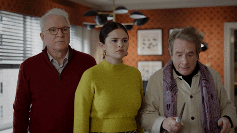 Animated gif of Steve Martin, Selena Gomez, and Martin Short in Only Murders in the Building. Captioned: "Why am I holding this knife?" Short chucks a bloody knife towards the ceiling, where it sticks.