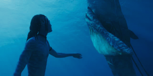 Animated gif of a Na'vi character touching a whale from Avatar