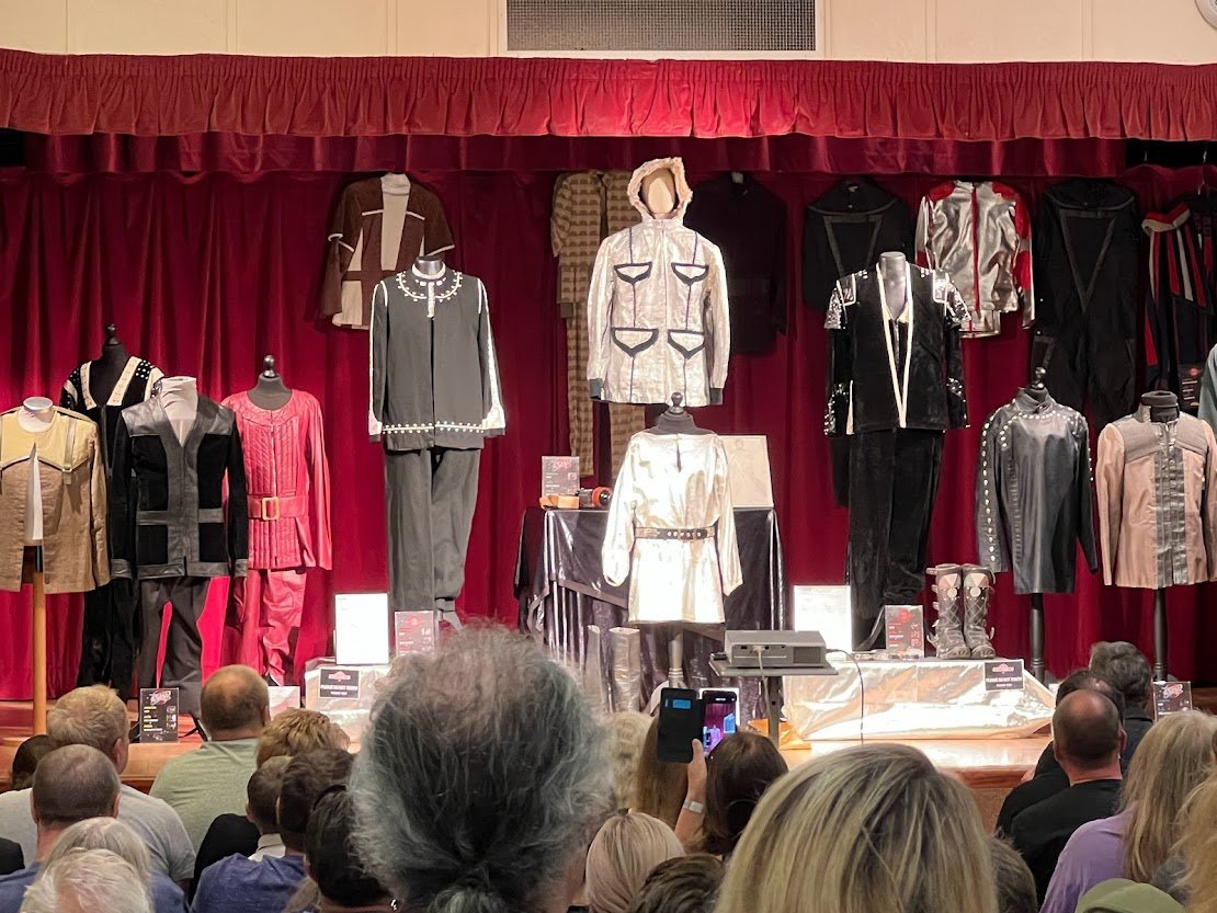 Image of a collection of costumes from the show on display