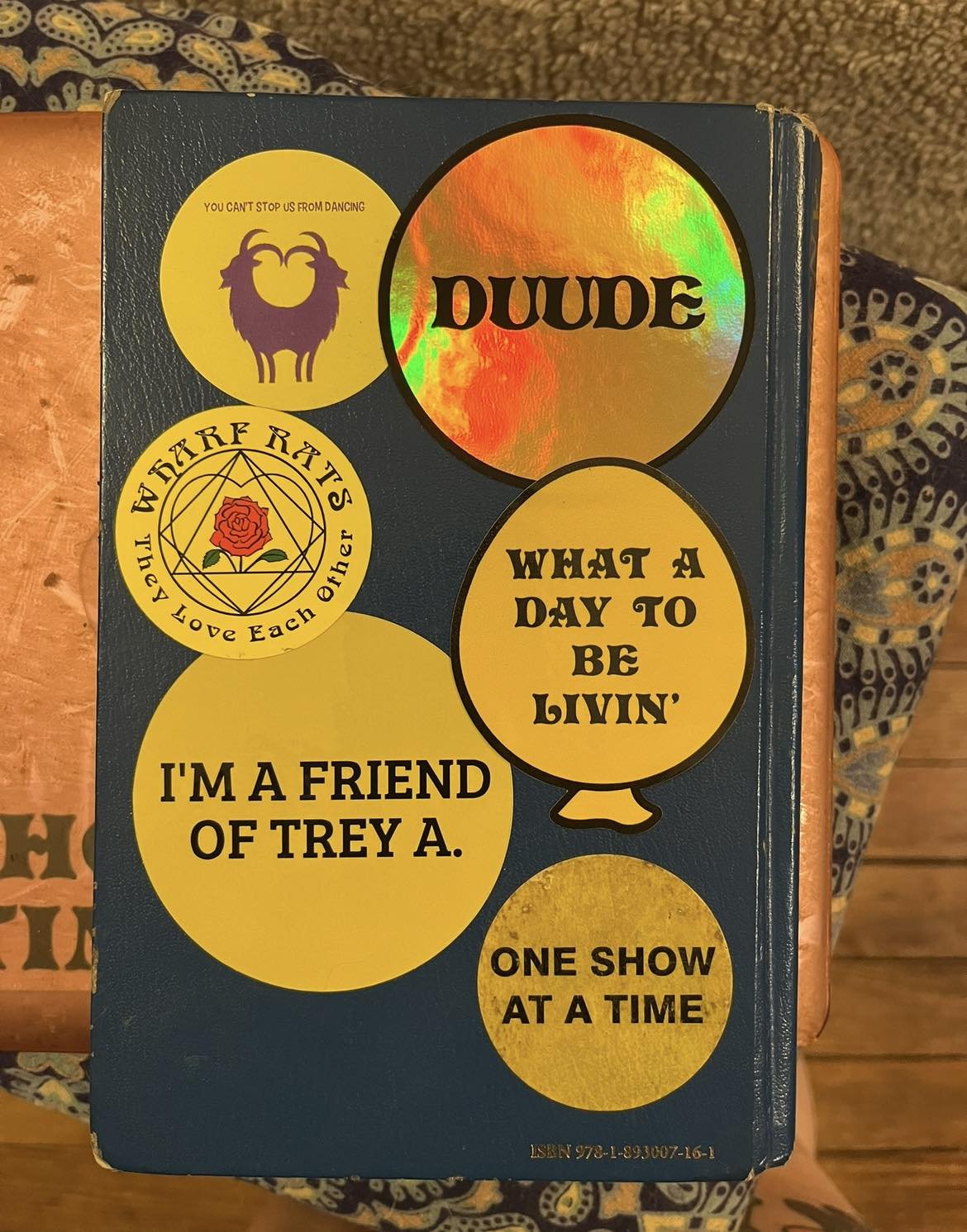 A black book covered with many yellow stickers.