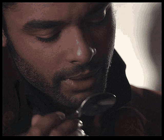  Animated gif of Regé-Jean Page licking a spoon. 