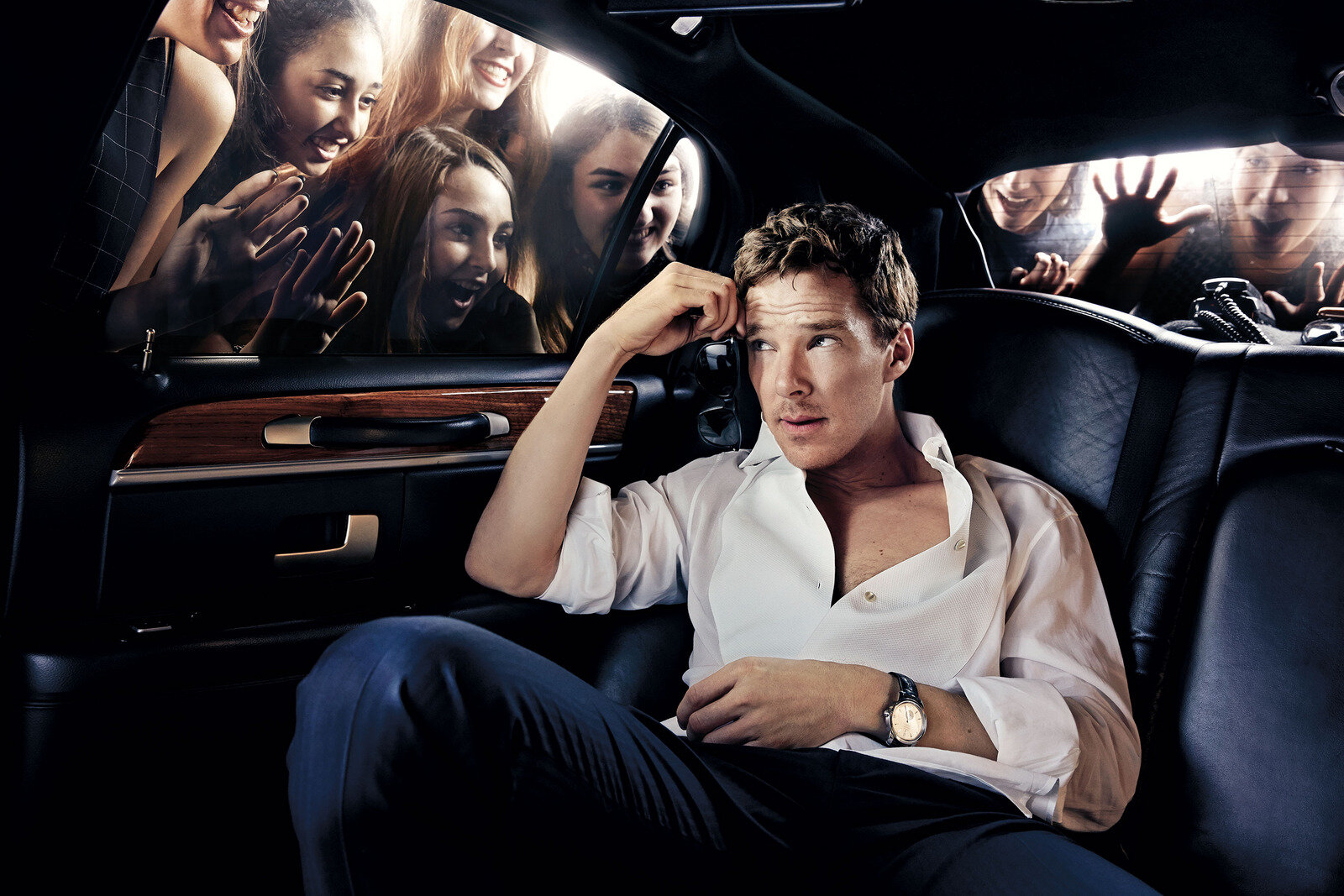  Benedict Cumberbatch in a limo with girls pressing on the windows staring at him. 
