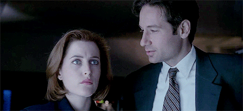 Animated gif of Scully and Mulder looking at each other.