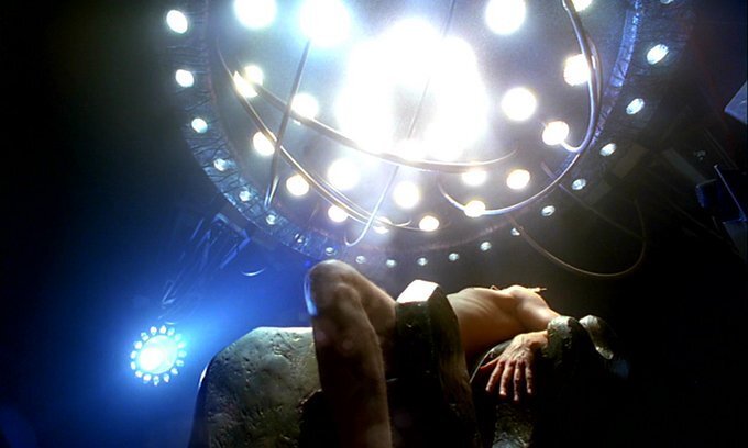 Still image of Fox Mulder strapped to a torture device beneath bright lights