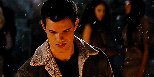 Animated gif of Jacob from Twilight, in a coat and standing in the snow.