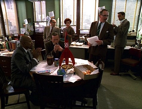 Still from "Far Beyond the Stars" of the DS9 cast in mid-century outfits in an office