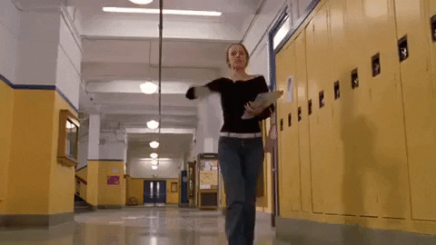  A gif of Regina George flinging Burn Book pages throughout the halls 